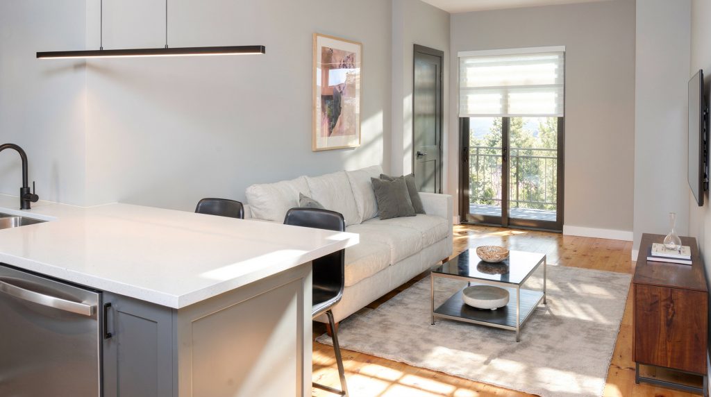 Forest Edge Place open-concept living and kitchen with breakfast bar seating